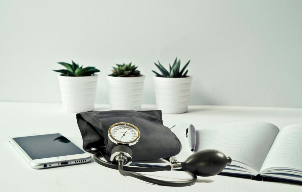 Blood pressure cuff, notebook, and pen.